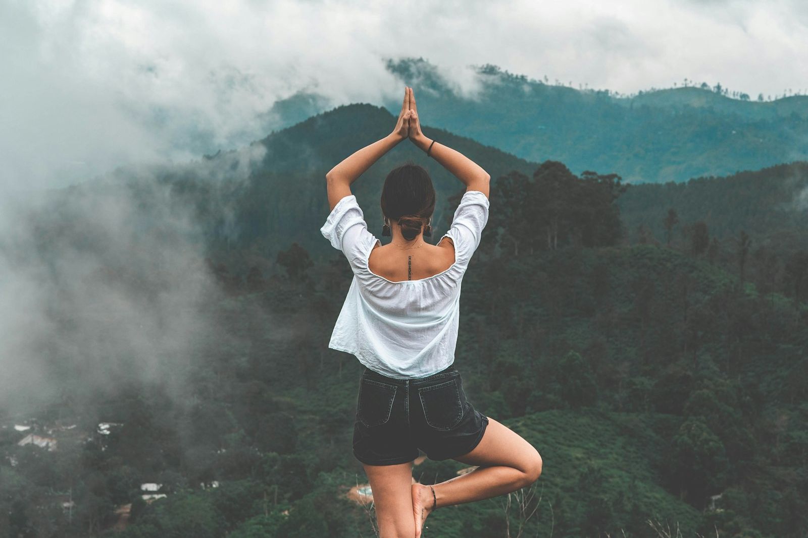 Yoga instructor adjusting a pose in soft morning light